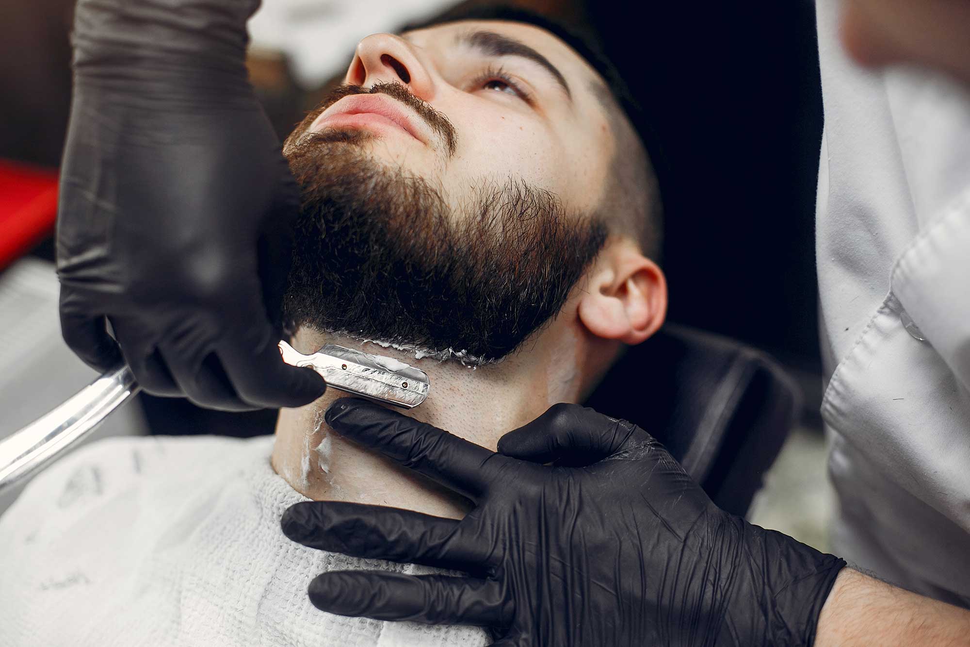 Expert barber shaping a man’s beard with clean lines and balanced length for a polished, well-groomed look at Las Vegas, NV Barbershop.