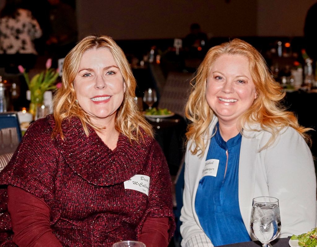 Event photography. 2 women smiling at the camera.