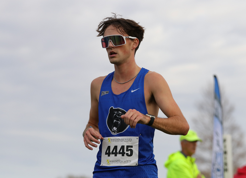 Sports photography. Man in track uniform and sunglasses.