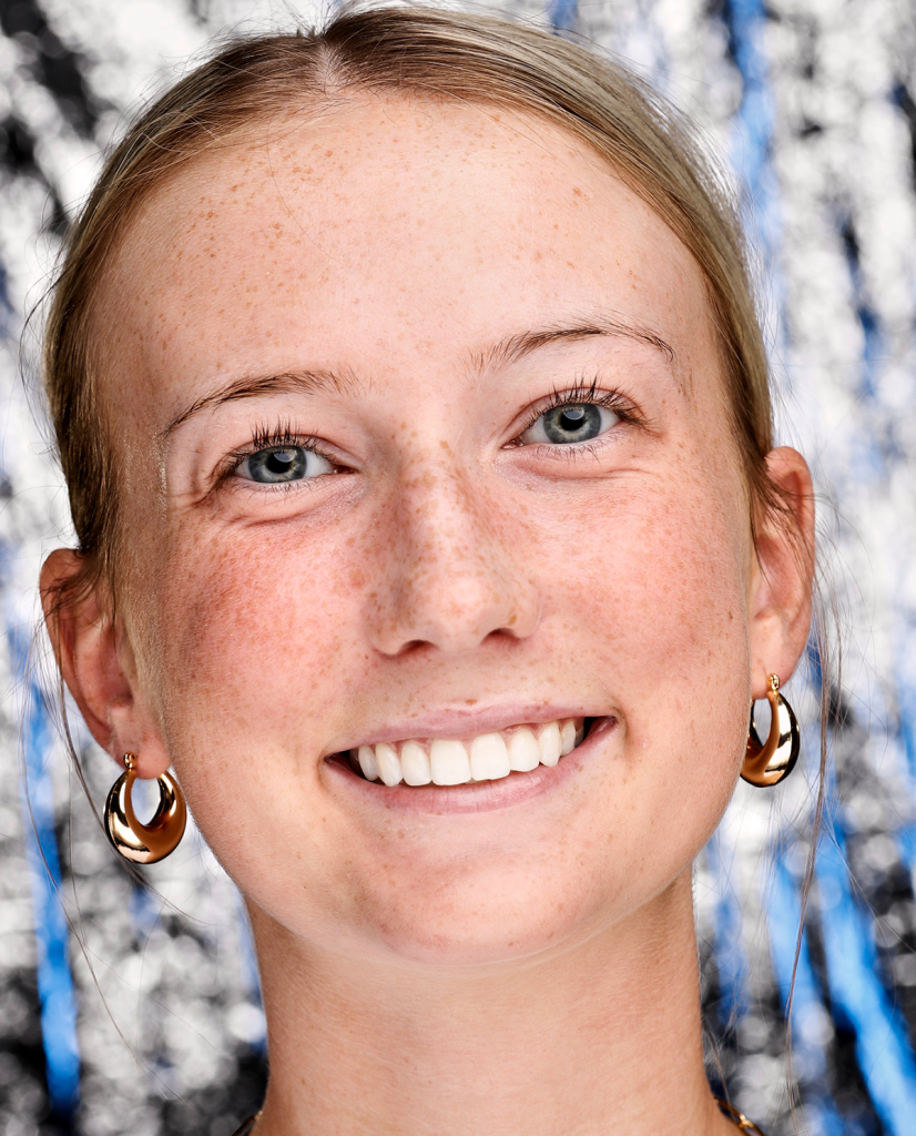 Portrait photography. Woman with her hair pulled back smiling.