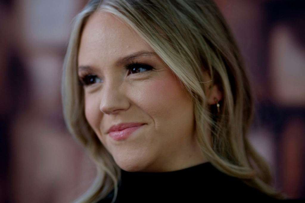 Portrait photography. Young woman with blonde hair smiling.