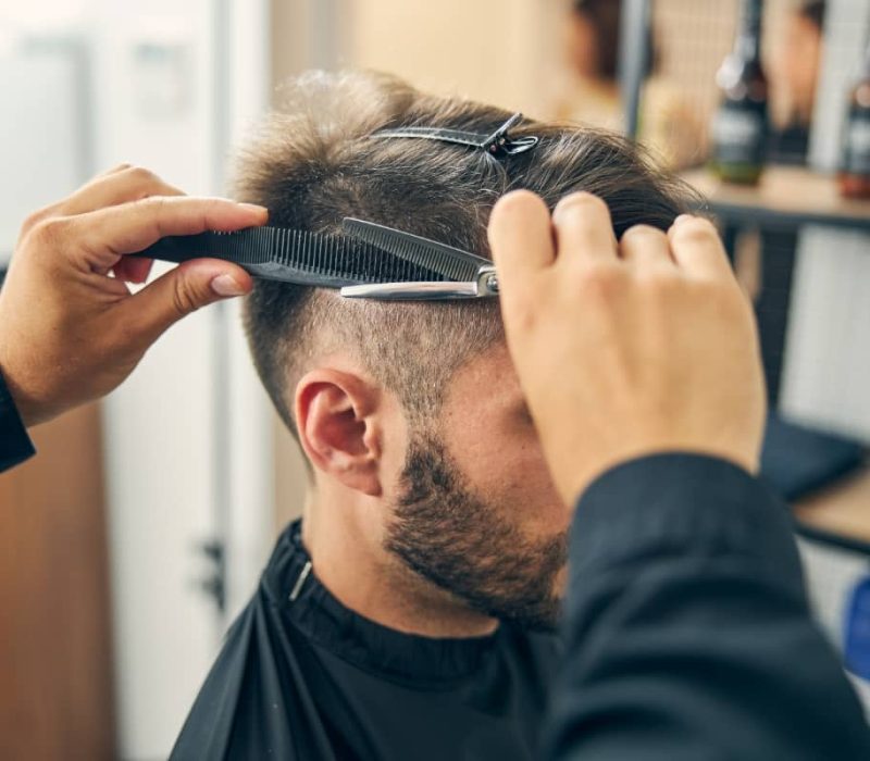 An image of a male customer getting his hair cut